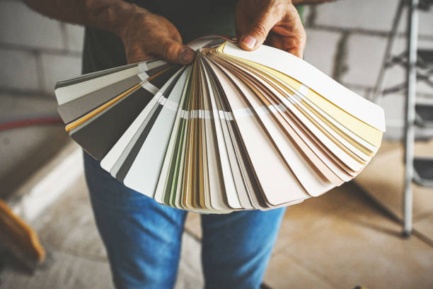 worker doing renovations in an apartment, color swatch,