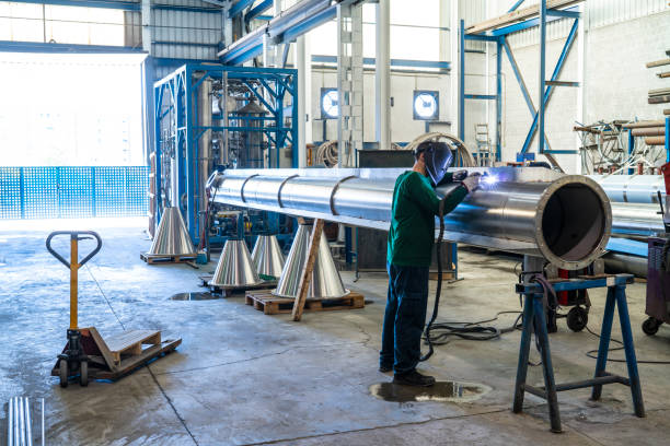 welder welding stainless steel big pipe at industry workshop