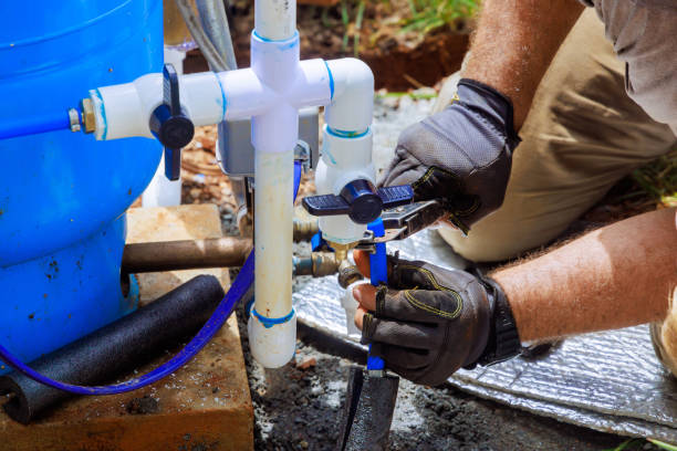 pvc water pipe is being connected to pump house for artesian well system
