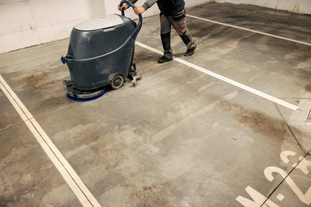 an unrecognizable worker washing garage with washing machine.