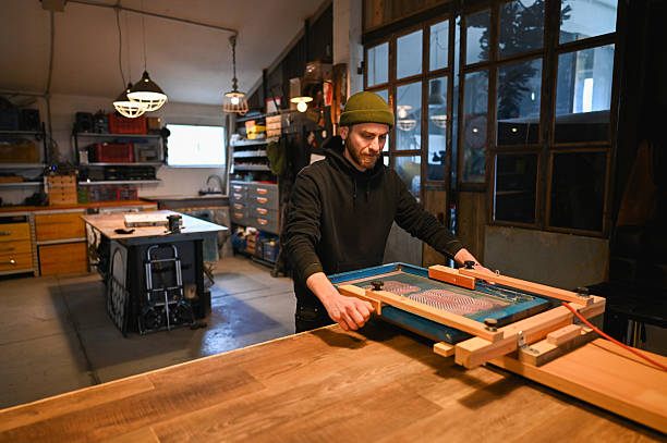 craftsman adjusting screen printing frame in his workshop