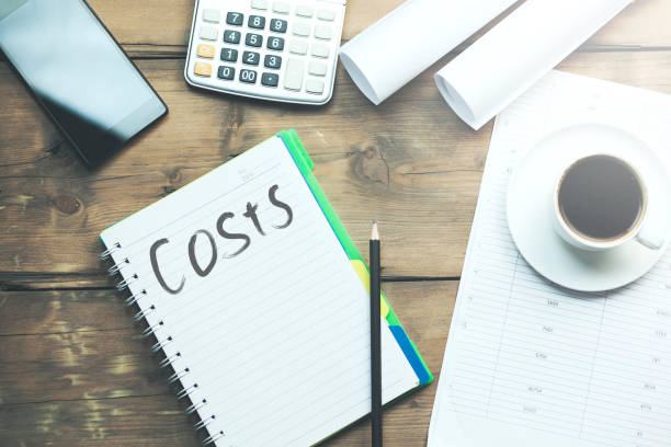 costs text on notebook on working table